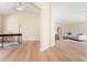 Spacious living area featuring wood-look floors and view to the living room and office space at 5105 Gato Del Sol Cir, Wesley Chapel, FL 33544