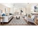 Comfortable living space featuring vaulted ceilings, wood-look floors, neutral paint, and modern furniture at 5105 Gato Del Sol Cir, Wesley Chapel, FL 33544