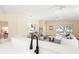 Open living room viewed from the kitchen features neutral tones, modern decor, and sliding door access to backyard at 5105 Gato Del Sol Cir, Wesley Chapel, FL 33544