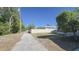 Gravel alleyway with access to backyard featuring a white fence and mature trees at 515 34Th Ne Ave, St Petersburg, FL 33704