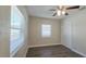 This bright bedroom features wood-look floors, a ceiling fan, and a closet with sliding doors at 515 34Th Ne Ave, St Petersburg, FL 33704