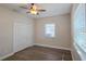 This bright bedroom features wood-look floors, a ceiling fan, and a closet with sliding doors at 515 34Th Ne Ave, St Petersburg, FL 33704