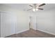 This bright bedroom features wood-look floors, a ceiling fan, and a closet with sliding doors at 515 34Th Ne Ave, St Petersburg, FL 33704