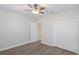 This bright bedroom features wood-look floors, a ceiling fan, and a closet with sliding doors at 515 34Th Ne Ave, St Petersburg, FL 33704