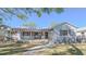 Charming single-story home with a pergola-covered front porch, stone accents, and a well-manicured lawn at 515 34Th Ne Ave, St Petersburg, FL 33704