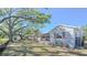 Beautiful home with a welcoming front porch, lush landscaping, and mature trees at 515 34Th Ne Ave, St Petersburg, FL 33704