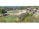 Scenic aerial view of a golf course with lush greenery, sand traps, and blue water at 515 34Th Ne Ave, St Petersburg, FL 33704