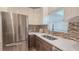 Bright kitchen with stainless steel appliances, white cabinets, mosaic backsplash, and a stainless steel sink at 515 34Th Ne Ave, St Petersburg, FL 33704