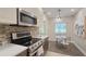 Updated kitchen with stainless steel appliances, quartz countertops, and a view of the adjacent dining area at 515 34Th Ne Ave, St Petersburg, FL 33704