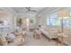 Bright living room with neutral decor, hardwood floors, a ceiling fan, and views of the front yard at 515 34Th Ne Ave, St Petersburg, FL 33704