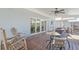 Inviting covered patio with ceiling fan, wood floors, and comfortable seating area at 515 34Th Ne Ave, St Petersburg, FL 33704
