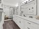 Bright bathroom featuring a double sink vanity, modern black fixtures, and glass shower with marble tile at 523 Bayport Way # 523, Longboat Key, FL 34228