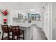 Modern kitchen with white cabinets, stainless steel appliances and bar seating at 523 Bayport Way # 523, Longboat Key, FL 34228