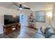 Inviting living room with a blue sofa, TV console, shelving unit, and modern ceiling fan at 523 Bayport Way # 523, Longboat Key, FL 34228