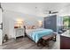 Cozy main bedroom with plank accent wall, wood floors, accent lighting, and a scenic view from the window at 523 Bayport Way # 523, Longboat Key, FL 34228