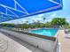 Beautiful view of the community pool featuring lounge chairs and lush greenery on a sunny day at 523 Bayport Way # 523, Longboat Key, FL 34228