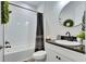 This bathroom showcases a shower-tub combination, updated fixtures and a vanity with a vessel sink at 5402 Limelight Dr, Apollo Beach, FL 33572
