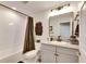 Features a shower-tub combination, updated fixtures and a granite topped vanity with modern lighting at 5402 Limelight Dr, Apollo Beach, FL 33572