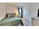 Cozy bedroom features neutral walls and carpet, a stylish bed, and a view of a window with blinds at 5402 Limelight Dr, Apollo Beach, FL 33572