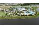 Aerial view of community pool, clubhouse, tennis courts, playground and parking area at 5402 Limelight Dr, Apollo Beach, FL 33572