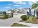 Charming two-story home featuring a paved driveway, well-kept lawn, and a spacious two-car garage at 5402 Limelight Dr, Apollo Beach, FL 33572