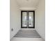 Inviting entryway featuring double doors and a striped rug, creating a warm welcome at 5402 Limelight Dr, Apollo Beach, FL 33572