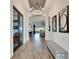 Elegant hallway features wood-look tile flooring, archways, decorative lighting, and a stylish bench at 5402 Limelight Dr, Apollo Beach, FL 33572