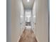 Hallway leading to bathroom with gray double vanity, modern lighting, and tiled shower at 5402 Limelight Dr, Apollo Beach, FL 33572