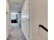 Hallway with closet doors; glimpse of upstairs den in neutral tones and stylish black and white curtains at 5402 Limelight Dr, Apollo Beach, FL 33572