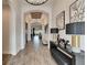 Long hallway with wood-look tile flooring, archways, decorative lighting, and console table with lamps at 5402 Limelight Dr, Apollo Beach, FL 33572