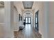 Well-lit hallway with wood-look tile flooring, archways, decorative lighting, and bench at 5402 Limelight Dr, Apollo Beach, FL 33572