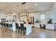 Bright, open kitchen with white cabinetry, stainless appliances, and large island with seating at 5402 Limelight Dr, Apollo Beach, FL 33572
