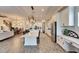 Open concept kitchen with a large island, stainless steel appliances, and white cabinets and an adjacent living area at 5402 Limelight Dr, Apollo Beach, FL 33572