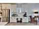 Bright kitchen area with stainless steel refrigerator and a cozy, dedicated workspace with white chair at 5402 Limelight Dr, Apollo Beach, FL 33572