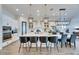 Gourmet kitchen with a large island, pendant lighting, and stainless steel appliances for a modern culinary experience at 5402 Limelight Dr, Apollo Beach, FL 33572
