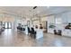 Open-concept kitchen with long island, white cabinets, stainless steel appliances, and hardwood style tile flooring throughout at 5402 Limelight Dr, Apollo Beach, FL 33572