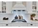 Modern kitchen with stainless steel appliances and custom cabinetry, including sleek white countertops and ample storage at 5402 Limelight Dr, Apollo Beach, FL 33572