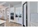 Kitchen area with stainless steel oven, microwave, and pantry, complemented by white cabinets and black hardware at 5402 Limelight Dr, Apollo Beach, FL 33572