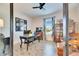 Inviting home office boasts desk, leather chairs, bookshelf and a large window with natural light at 5402 Limelight Dr, Apollo Beach, FL 33572