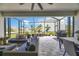 Covered patio with outdoor seating, ceiling fan, and screened enclosure, perfect for enjoying the outdoors in comfort at 5402 Limelight Dr, Apollo Beach, FL 33572