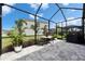 Screened-in patio with outdoor furniture and grill, offering a serene outdoor living space with lush green landscaping at 5402 Limelight Dr, Apollo Beach, FL 33572