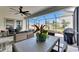 Covered patio with ceiling fan, outdoor furniture, grill and view to a landscaped backyard with adjacent residential homes at 5402 Limelight Dr, Apollo Beach, FL 33572