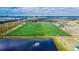 Aerial view of multiple sports fields with soccer goals, football markings, and tall stadium lighting at 5402 Limelight Dr, Apollo Beach, FL 33572