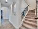 A view of a carpeted staircase with decorative railing and nearby archways enhance the visual appeal at 5402 Limelight Dr, Apollo Beach, FL 33572