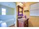 Bathroom featuring a vanity with granite countertop and a jetted tub in the background at 5741 Riddle Rd, Holiday, FL 34690