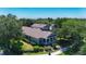 Aerial view of a two-story home with covered front porch, mature trees, and lush landscaping at 6002 Churchside Dr, Lithia, FL 33547