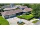 Spacious home with a three-car garage and a manicured lawn as seen from an aerial perspective at 6002 Churchside Dr, Lithia, FL 33547