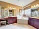 Elegant bathroom featuring dual vanities, a soaking tub, and a chandelier at 6002 Churchside Dr, Lithia, FL 33547