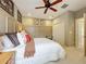 Comfortable bedroom with a ceiling fan, neutral walls, and a spacious closet at 6002 Churchside Dr, Lithia, FL 33547
