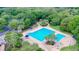 Large outdoor pool with lap lanes, adjacent leisure pool, lounge chairs, and lush landscaping at 6002 Churchside Dr, Lithia, FL 33547